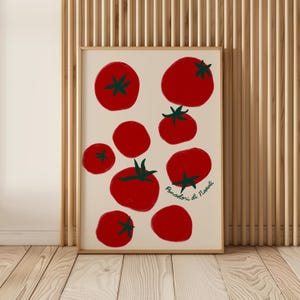 May include: A framed art print featuring a collection of red tomatoes with green stems on a cream background. The tomatoes vary in size and are arranged in a scattered pattern. The text "Pomadori di Napoli" is written in green.