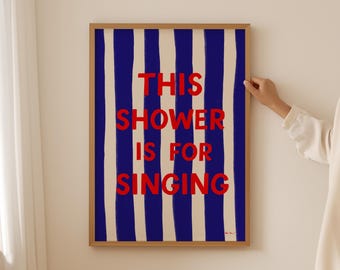 May include: A framed print with blue and white stripes and the text "This shower is for singing" in red.