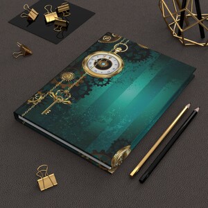 May include: A journal with a teal and green cover featuring a gold pocket watch, gears, and a key design. Gold-colored binder clips and pencils are also visible, creating a steampunk aesthetic.