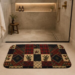 May include: A rectangular bath mat featuring a patchwork design of red, green, and navy blue plaid patterns interspersed with squares displaying illustrations of green pine sprigs and red holly berries on a cream-colored background.