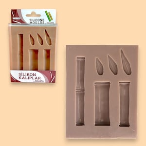 Könnte beinhalten: Eine Silikonform zum Herstellen von Kerzen in Form von Bambusstangen und Flammen. Die Form ist rosa und hat sechs Vertiefungen. Die Verpackung zeigt den Text "Silicone Molds" und "Silikon Kalıplar by Smarta".