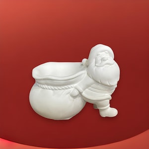 May include: White ceramic planter shaped like Santa Claus carrying a sack. The planter is designed to hold small plants or flowers.