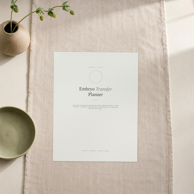 May include: A white rectangular planner page titled Embryo Transfer Planner in dark grey text. The page features a circular icon, a subtitle, and a paragraph of text below the title. The document is printed on a light-coloured paper sheet.