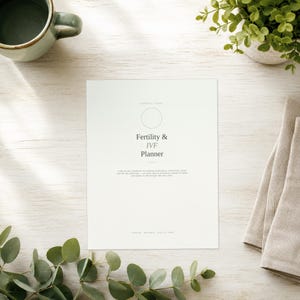 May include: A white paper planner titled Fertility & IVF Planner with a circular icon at the top. The text includes a subtitle about tracking medication, monitoring cycles, and the two-week wait, with footer text indicating it is digital and printable.