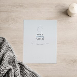May include: A white rectangular paper sheet featuring the text Weekly Wellbeing Check-In, a circular outline, and smaller text below. The document includes the words CLEAN DAYS at the top and the words LIFESTYLE, PRINTABLE, PRINT AT HOME at the bottom.