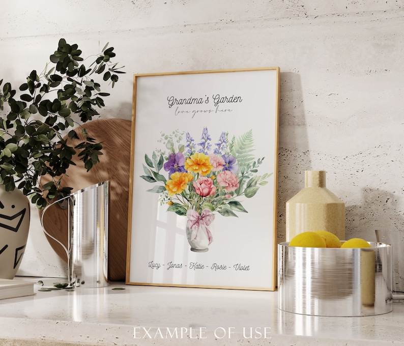 May include: A framed print with a watercolor illustration of a bouquet of flowers in a vase. The text "Grandma's Garden, love grows here" is at the top of the print. The names Lucy, Jonas, Katie, Rosie, and Violet are listed at the bottom.