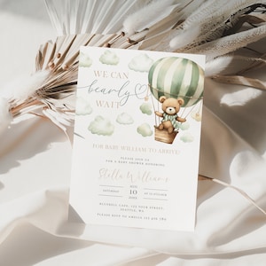 May include: A baby shower invitation with a watercolor illustration of a teddy bear in a hot air balloon. The invitation says "We can bearly wait" for baby William to arrive. The event is scheduled for August 10th at 12 o'clock at Bluebell Cafe.