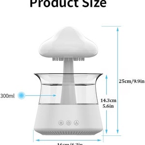May include: White mushroom-shaped ultrasonic humidifier with a clear water tank and a base with three buttons. The humidifier is 9.9 inches tall, 5.6 inches wide, and 6.3 inches in diameter. It has a capacity of 300 ml.