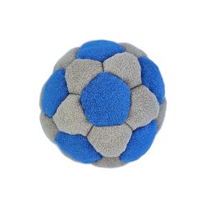 May include: A soft, textured ball with a soccer ball design. The ball is made of blue and gray fabric. The ball is round and has a geometric pattern.