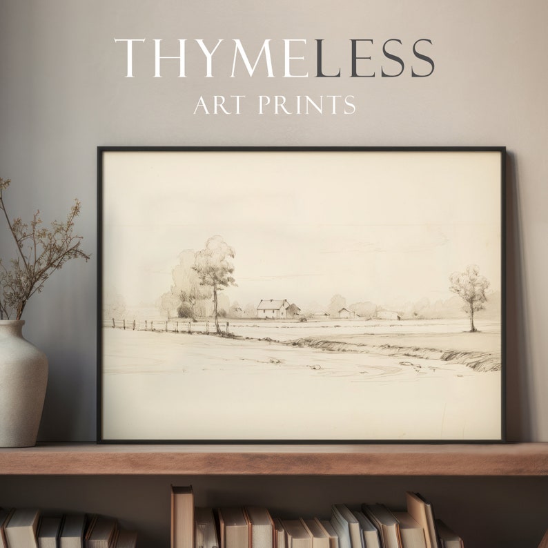 May include: A black and white drawing of a rural landscape with a farmhouse and trees. The drawing is framed in a black frame and is hanging on a wall.
