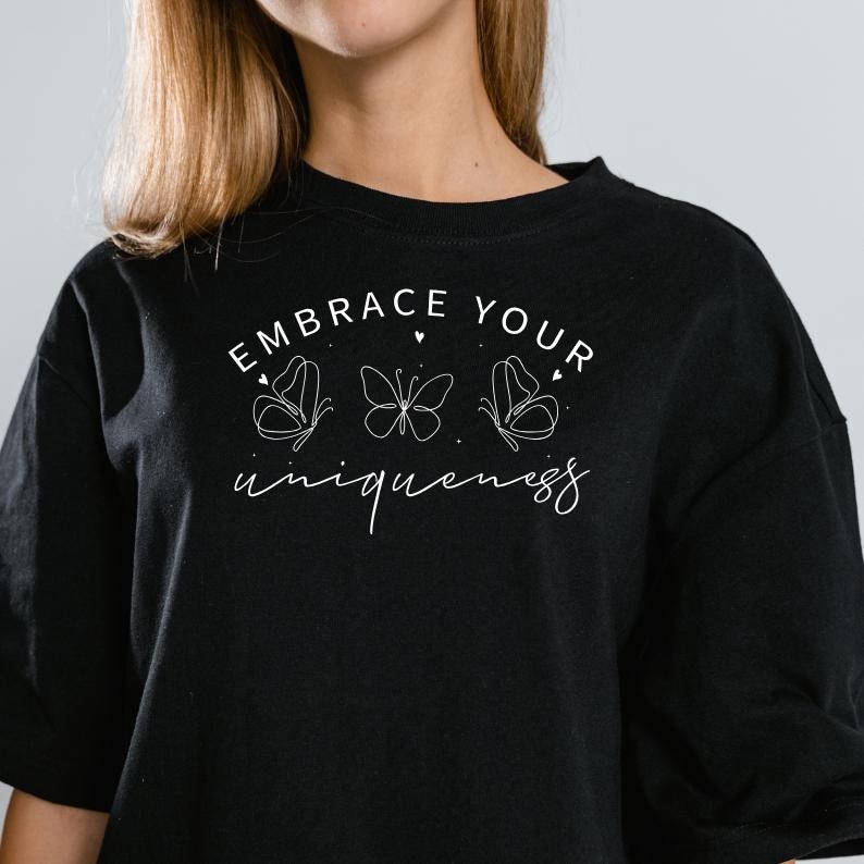 May include: Black oversized t-shirt with white text that reads "Embrace Your Uniqueness" and three butterfly illustrations.