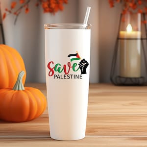 May include: White stainless steel tumbler with a black fist holding a Palestinian flag and the text "Save Palestine".