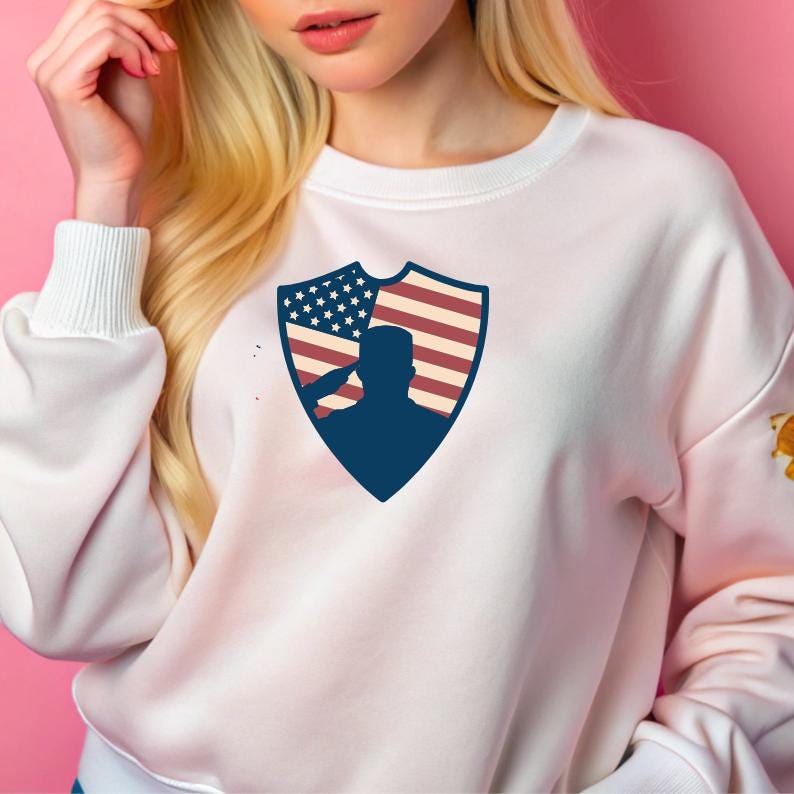 May include: White sweatshirt with a blue shield design featuring a silhouette of a person saluting in front of an American flag.