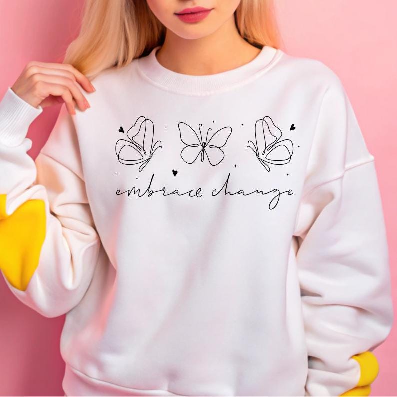 May include: White sweatshirt with a black line drawing of three butterflies and the text "embrace change".
