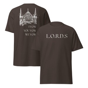 May include: Two brown t-shirts with white text. The front shirt has the text "L.O.R.D.S." The back shirt has a drawing of a church with the text "I Vow You Vow We Vow"