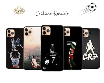 May include: Five different iPhone cases featuring Cristiano Ronaldo, a famous soccer player. The cases are black with white designs. One case features Ronaldo holding a trophy, another features him in a soccer uniform, and another features him in a black jersey with the number 7. The other two cases feature the number 7 and the letters CR7.