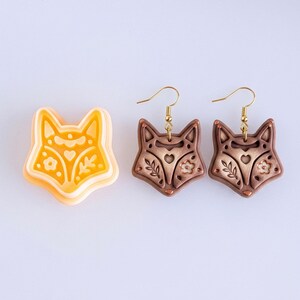 Scandi folk fox polymer clay cutter with matching brown mirrored earrings, featuring clean lines and symmetrical folk style details