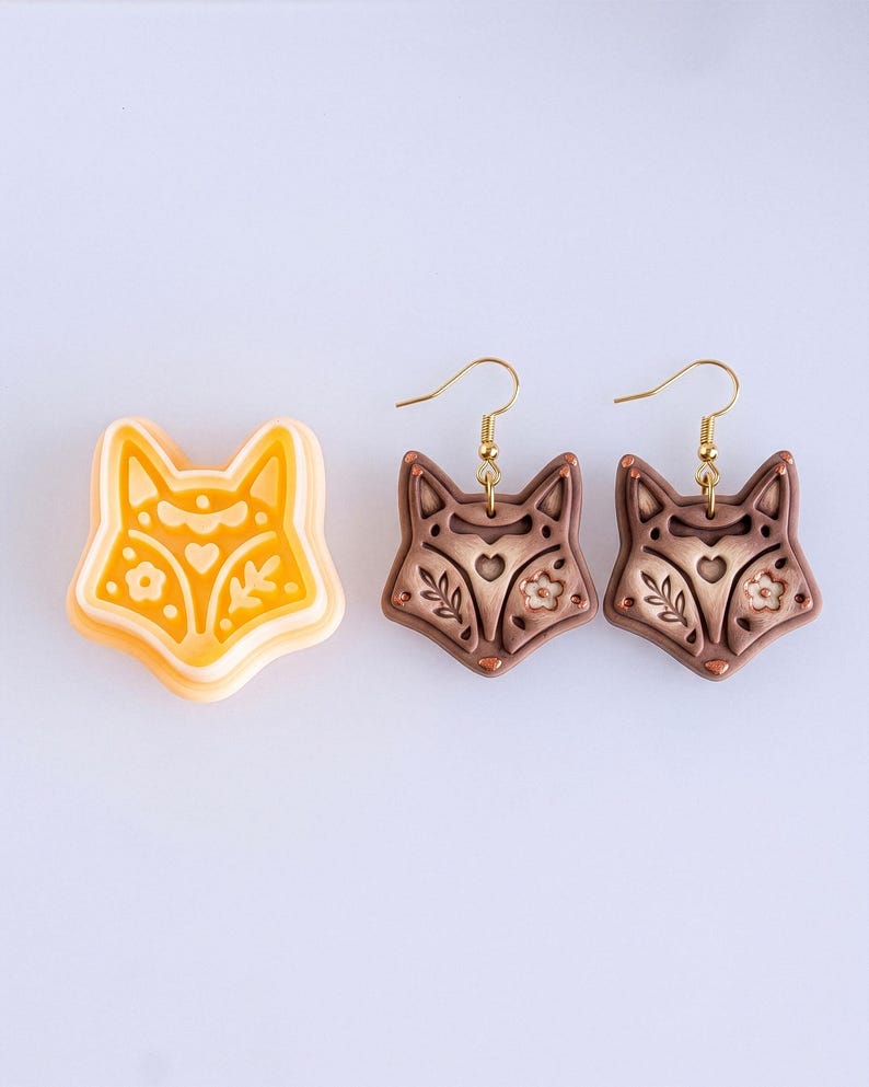 Scandi folk fox polymer clay cutter with matching brown mirrored earrings, featuring clean lines and symmetrical folk style details