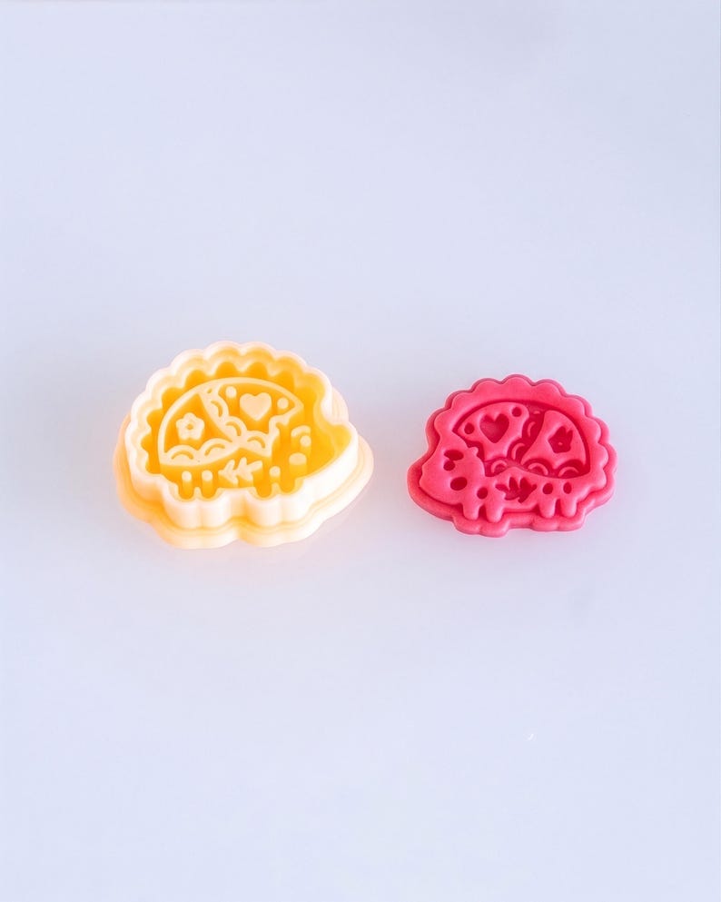 Scandi folk hedgehog polymer clay cutter with finished clay piece in vibrant pink, featuring bold and playful imprint design