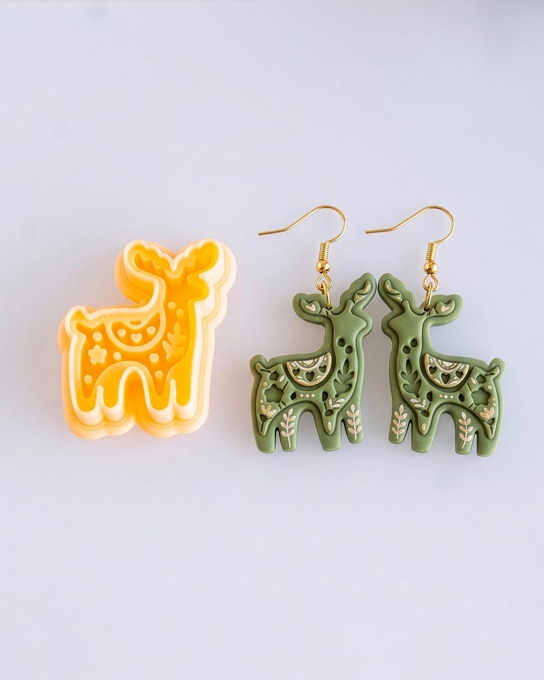Scandi folk deer polymer clay cutter with mirrored earring pair in moss green, showing detailed imprint design