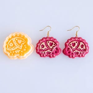 Scandi folk hedgehog polymer clay cutter with matching pink mirrored earrings, showing crisp and detailed imprint pattern