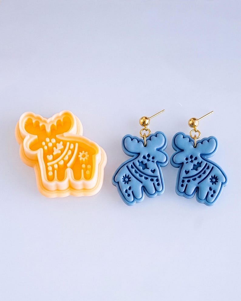 Scandi folk moose polymer clay cutter with matching blue mirrored earrings, showing crisp and bold imprint pattern