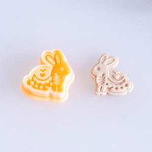 Scandi folk bunny polymer clay cutter with finished clay piece in soft off white, featuring delicate folk style imprint