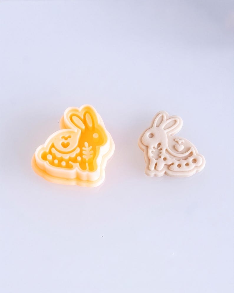 Scandi folk bunny polymer clay cutter with finished clay piece in soft off white, featuring delicate folk style imprint