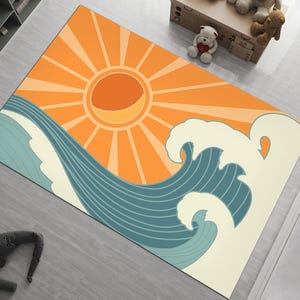 Puede incluir: Alfombra rectangular con un diseño estilizado de sol y olas del océano. El sol es naranja con rayos amarillos, y las olas son verde azulado y blanquecino. Para uso en interiores.