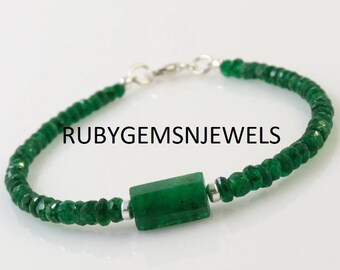 May include: A green gemstone bracelet with a rectangular center stone and small, faceted beads. The bracelet is strung on a silver chain and features the text "RUBYGEMS&JEWELS".