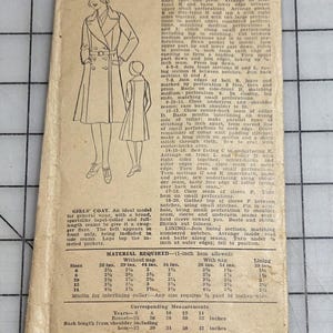 May include: A vintage Excella Patterns envelope for a coat, size 10, priced at 25 cents. The tan paper features a black-and-white illustration of a coat with a lapel collar and belt, alongside detailed sewing instructions, material requirements, and measurements.