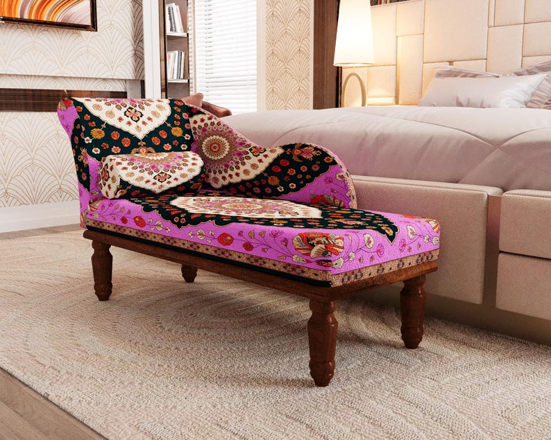 A colorful, patterned armchair with a floral design sits in a bedroom, accompanied by a white bed and a beige headboard.