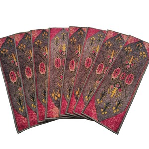 May include: A set of nine patterned stair treads in red, brown and gold. The treads feature a geometric design with a repeating pattern.