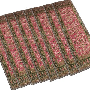 May include: Set of seven pink and green patterned runner rugs. The rugs have a floral design with a border.