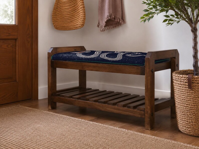 a wooden bench with a blue cushion, placed on a wooden floor next to a woven basket and a potted plant.