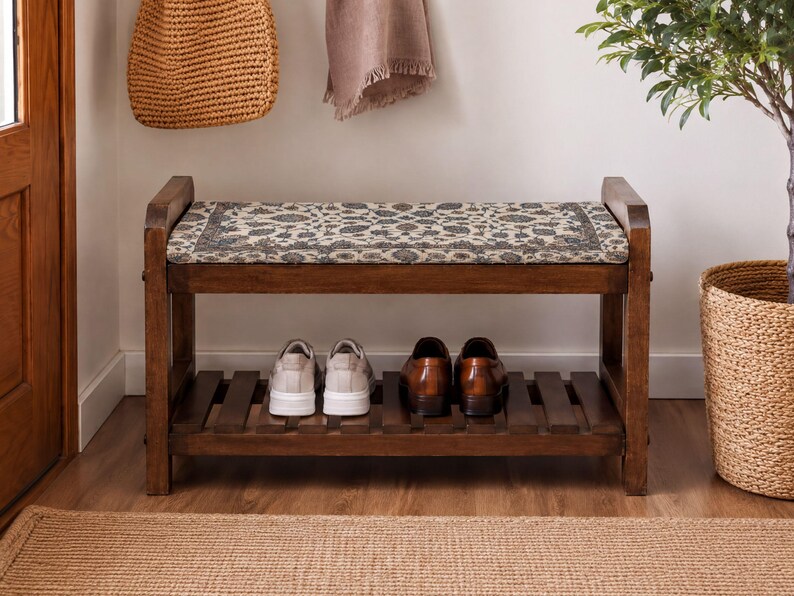 A wooden bench with a patterned seat and storage space for shoes, situated in a hallway with a woven basket and a potted plant nearby.
