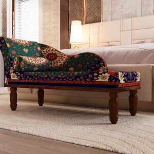 a modern and stylish bedroom with a large bed, a colorful patterned chair, and a white headboard.
