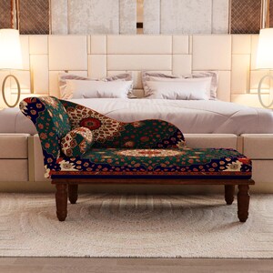 a luxurious bedroom with a large bed, a patterned armchair, and two floor lamps on either side of the bed.