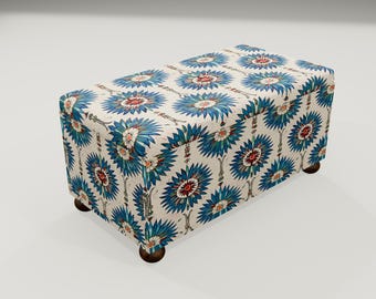 May include: A white storage ottoman with a blue and white floral pattern. The ottoman has four wooden legs.