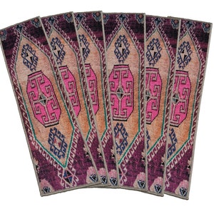 May include: Set of six pink and purple patterned runner rugs with a geometric design. The rugs are made of a soft, woven material and have a fringed edge.