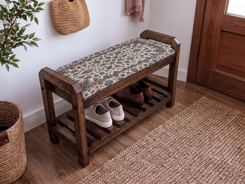 A wooden bench with a woven seat and storage space underneath, situated in a room with a woven basket and a rug on the floor.