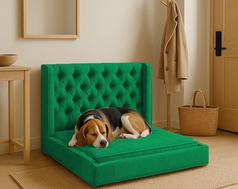 May include: A green velvet dog bed with a tufted headboard and a dog sleeping on it.