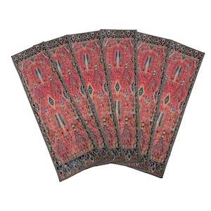 May include: Six red, blue and green patterned fabric placemats with a geometric design. The placemats are arranged in a fan shape.