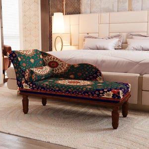 a cozy bedroom with a large bed, a colorful patterned armchair, and a white headboard.