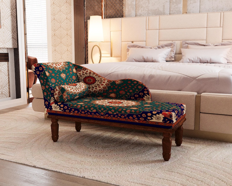 a cozy bedroom with a large bed, a colorful patterned armchair, and a white headboard.