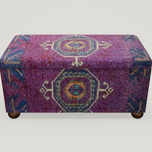 May include: A purple storage ottoman with a colorful patterned fabric top. The ottoman has a rectangular shape and wooden legs.