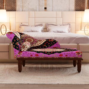 a luxurious bedroom with a large bed, a colorful patterned armchair, and two floor lamps on either side of the bed.