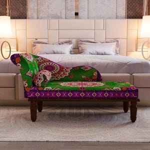 a luxurious bedroom with a large bed, a colorful patterned bench, and two floor lamps on either side of the bed.