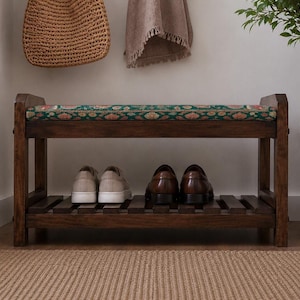 A wooden shoe rack with two shelves, displaying a pair of shoes on the lower shelf and a woven basket on the upper shelf.