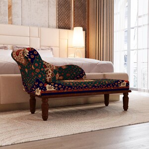 a modern bedroom with a large bed, a colorful patterned armchair, and a window with curtains.
